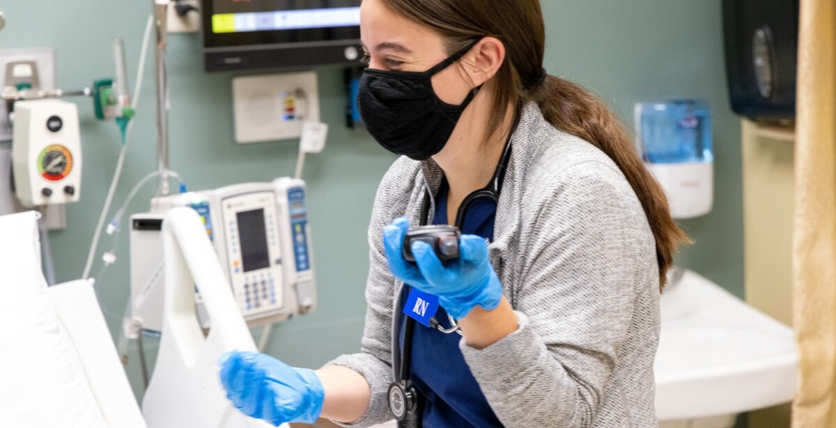 euo student holding medical device