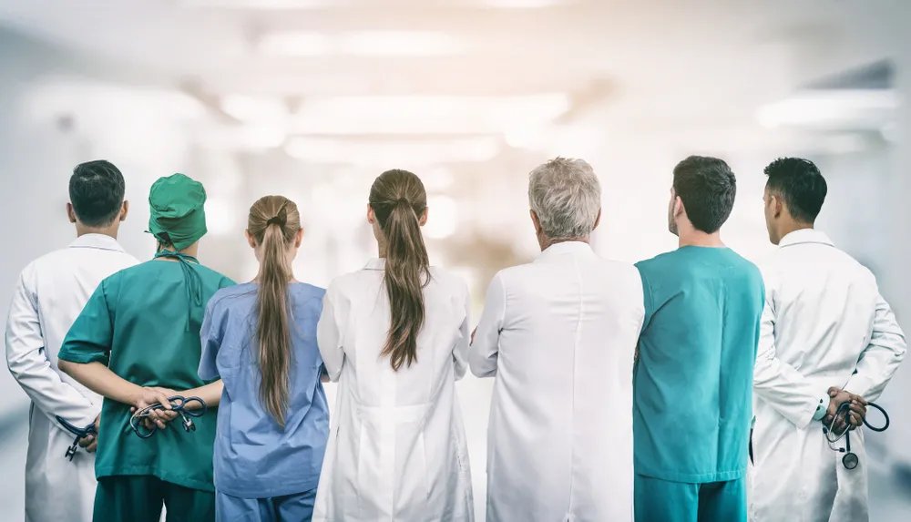 Nurses and nurse practitioners lined up facing away from the camera