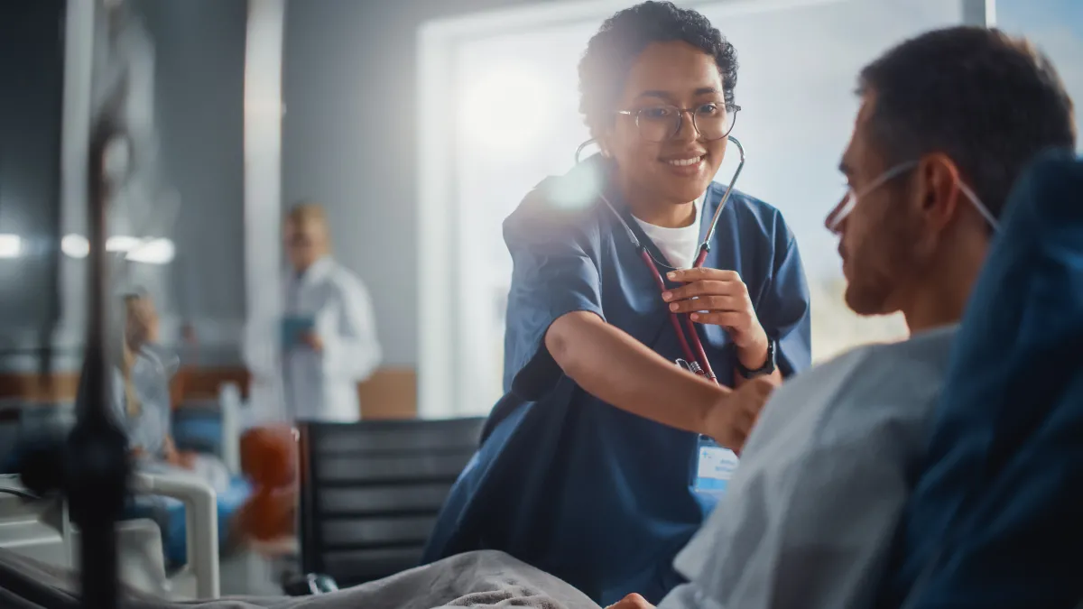 smiling nurse working with a patient