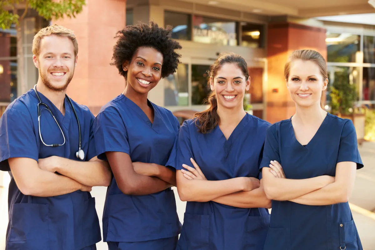 Nursing students standing in front of their school