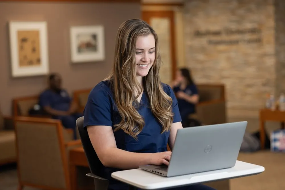 An Elmhurst nursing student doing online coursework